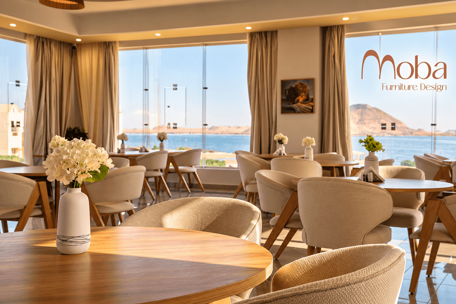 Sea-view hotel restaurant dining area with round wooden tables and cream chairs – Moba Furniture project