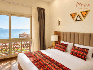 Sea-view hotel bedroom with upholstered headboard – Moba Furniture